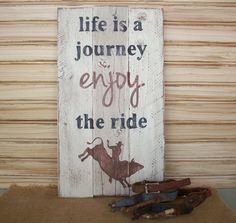 a wooden sign that says life is a journey enjoy the ride and some old scissors