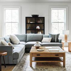 a living room filled with furniture and windows