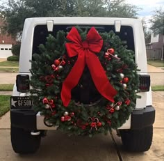 a christmas wreath on the back of a white truck