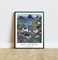 the isle of skye poster is displayed on a wooden floor in front of a white wall