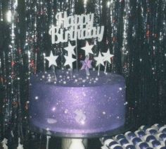 a purple birthday cake with stars on it