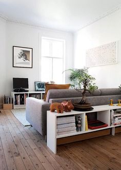 a living room with white walls and wooden floors