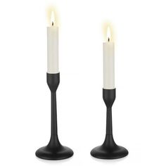 two black candles with one white candle in the middle