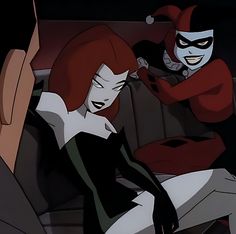 two animated characters sitting in the back seat of a car, one with red hair