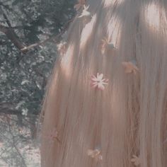 the back of a woman's head with long blonde hair and butterflies on it