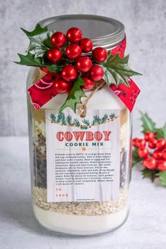 a jar filled with oatmeal and berries on top of a white table