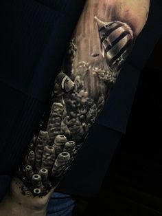 a man's arm with an image of a mushroom and other things on it