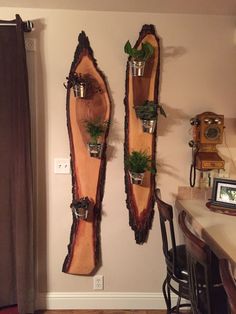 two wooden shelves with plants in them on the wall