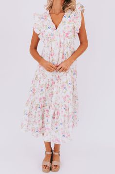 This flirty Take Me Back Dress is the perfect way to add some floral fun to your wardrobe. With a flattering V-neckline and playful ruffle details, you'll turn heads wherever you go. Don't miss out on this must-have piece. Details Floral pattern V-neckline Ruffle details Sizing Approximate measurements: SIZE LENGTH BUST Small 47" 38" Medium 48" 40" Large 49" 42" Fabric has no stretchModels are 5’10 wearing small Material 100% CottonHand wash coldHang to dry Feminine Floral Dress With Ruffle Hem For Daywear, Spring Midi Dress With Ruffled Straps For Daywear, Feminine Ditsy Floral Print Dress With Ruffled Straps, Feminine Floral Dress With Flutter Sleeves, Garden Party Floral V-neck Dress With Ruffle Hem, Tiered Floral Dress With Ruffles For Daywear, Floral Print Dresses With Ruffled Straps For Daywear, V-neck Floral Dress With Ruffles For Brunch, Daywear Dresses With Floral Print And Ruffled Straps