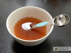 a bowl filled with liquid and a spoon