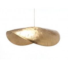 a gold colored light hanging from a wire on a white background with no one in it