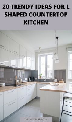 Modern L-shaped kitchen with white cabinets and wooden countertops, featuring pendant lights and a window for natural light. Kitchen Layouts With Island, Kitchen Island Design