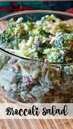 broccoli salad in a glass bowl on a wooden table