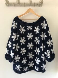 a blue sweater with white snowflakes on it