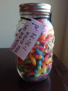 a jar filled with lots of different colored candies