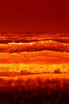 an orange and red sunset over the ocean