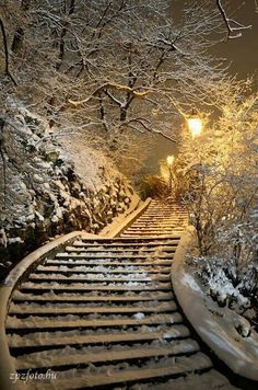 a train track covered in snow at night