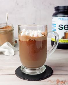 hot chocolate in a glass mug with marshmallows and sea salt on the side