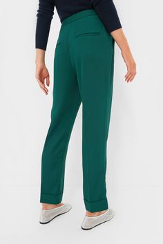 The ultimate closet staple in a fresh colorway, the Dark Green Duncan Pleated Trouser is the pair of pants that will complete your wardrobe and having you reaching for them on repeat. With a flattering high rise, elongating front pleats, and a chic straight leg silhouette, these are perfect from desk to drinks and everywhere in between. Pair them with a tailored blazer, a slouchy tee, or a cardigan — trust us, these can do it all! High rise Zip fly with hidden hook and eye closure Angled hip pockets Pleated front Straight leg Fixed cuff at hem Material: 100% Polyester Care: Machine wash cold, tumble dry low. Do not bleach, low iron if needed