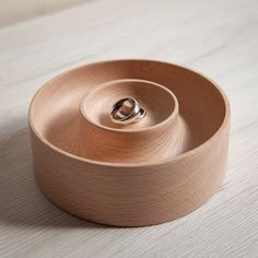 a wooden bowl sitting on top of a table