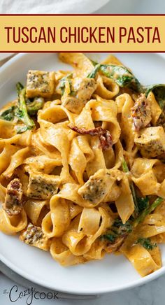 a white plate topped with pasta covered in chicken and spinach sauce next to a fork