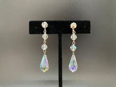 "These gorgeous crystal earrings throw off light and color as you move.  They have adjustable screw-backs in silver-tone metal.  They are made of three round, cut-crystal beads and end with a large cut-crystal teardrop.  They measures 2\" long and are in beautiful vintage condition as shown." Teardrop Crystal Earrings With Faceted Beads, Silver Teardrop Clip-on Crystal Earrings, Silver Teardrop Crystal Clip-on Earrings, Crystal Earrings Diy, Handmade Jewelry Diy, Crystal Drop Earrings, Crystal Drop, Screw Back Earrings, Jewelry Diy