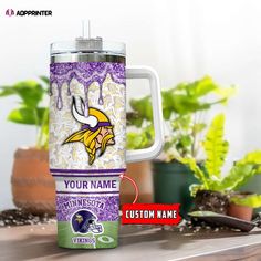 the minnesota vikings travel mug is next to some potted plants