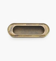 an antique brass drawer handle on a white background