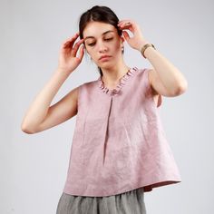 Casual, playful, elegant, the all-in one summer top. Detailed with delicate ruffles around the V neckline, this timeless top offers a luxurious feel and an effortless look. The front pleat detail adds volume to the already flared silhouette. Shown in Pale Rose linen. FEATURES        *  Relaxed, cropped cut        *  Flared with front pleat        *  Ruffled V-neck  SIZES        *   See size chart photo. If not sure about the size, please send us you measurements and we will be happy to recommend Couture Invisible, Flared Top, Linen Clothing, Pleat Top, Fashion Dresses Casual, Top Cropped, Linen Top, Linen Clothes, Sleeveless Blouse