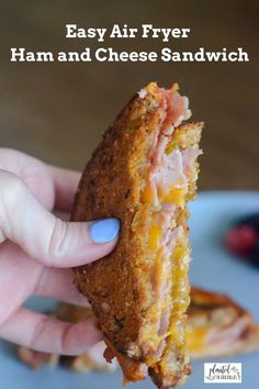 a hand holding a ham and cheese sandwich with the words easy air fryer ham and cheese sandwich