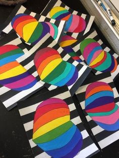 several pieces of art that have been made to look like rainbows on black and white stripes