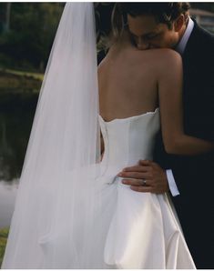 the bride and groom are embracing each other