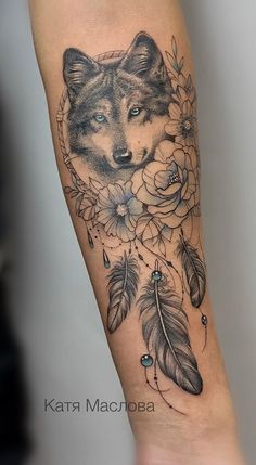 a tattoo with a wolf and flowers on the arm, done by kartna macroba