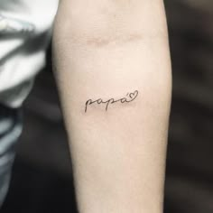 a person with a tattoo on their arm that says papao in cursive writing