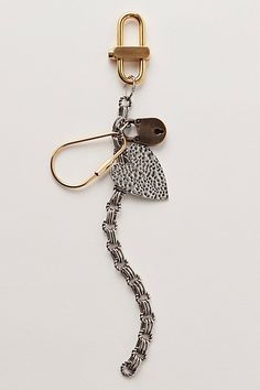 a keychain with a metal hook attached to it's side and a chain hanging from the end