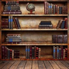 an old bookcase with many books and a small globe on the top shelf in front of it