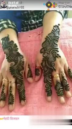 two hands with henna designs on them