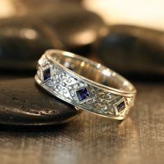 two wedding rings sitting on top of a table