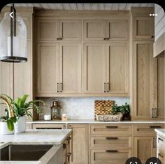 a kitchen filled with lots of wooden cabinets