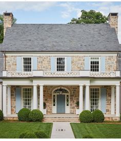 an old brick house with blue shutters and white trim