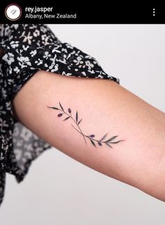 a woman's arm with a flower tattoo on the left side of her arm