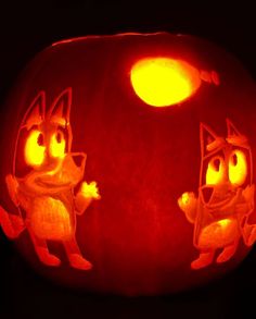 a carved pumpkin with an image of two cats in the middle and one cat on top