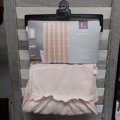 the bedding is pink and has ruffles on it, along with other items