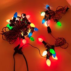 several christmas lights that are on the floor together, all lit up and ready to be used