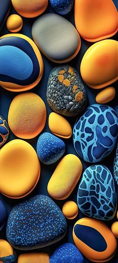 colorful rocks and pebbles are arranged in an abstract pattern with blue, orange, and yellow colors