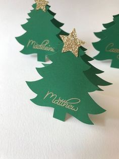 three green christmas trees with gold stars on them, and the words mathes written in gold