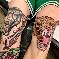 two people with tattoos on their legs, one has a tiger and the other is a cat