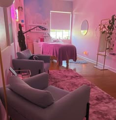 a living room filled with furniture and pink walls