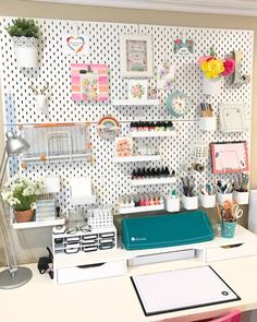 a white desk topped with lots of office supplies