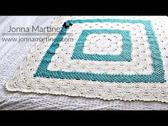 a crocheted blanket with the words let it be written in blue and white